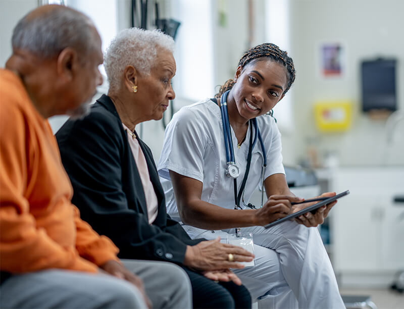 Older Couple Talking with Female Doctor