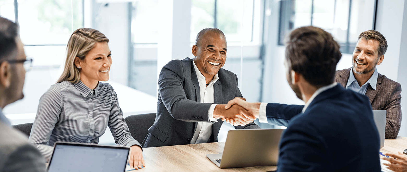 business owner meeting with bankers shaking hands