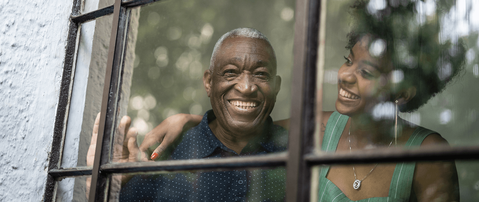 older man and daughter looking out window