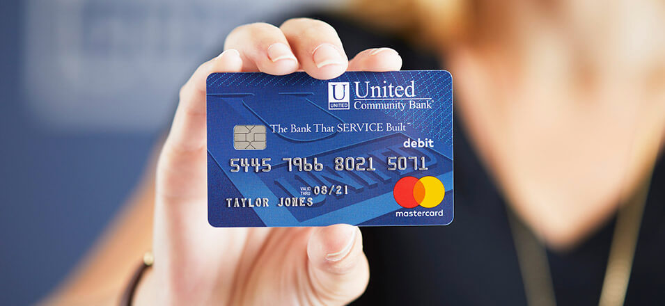 Hand holding United Community Bank Debit Card
