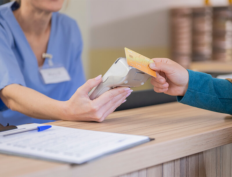 Healthcare Worker and Patient Paying 